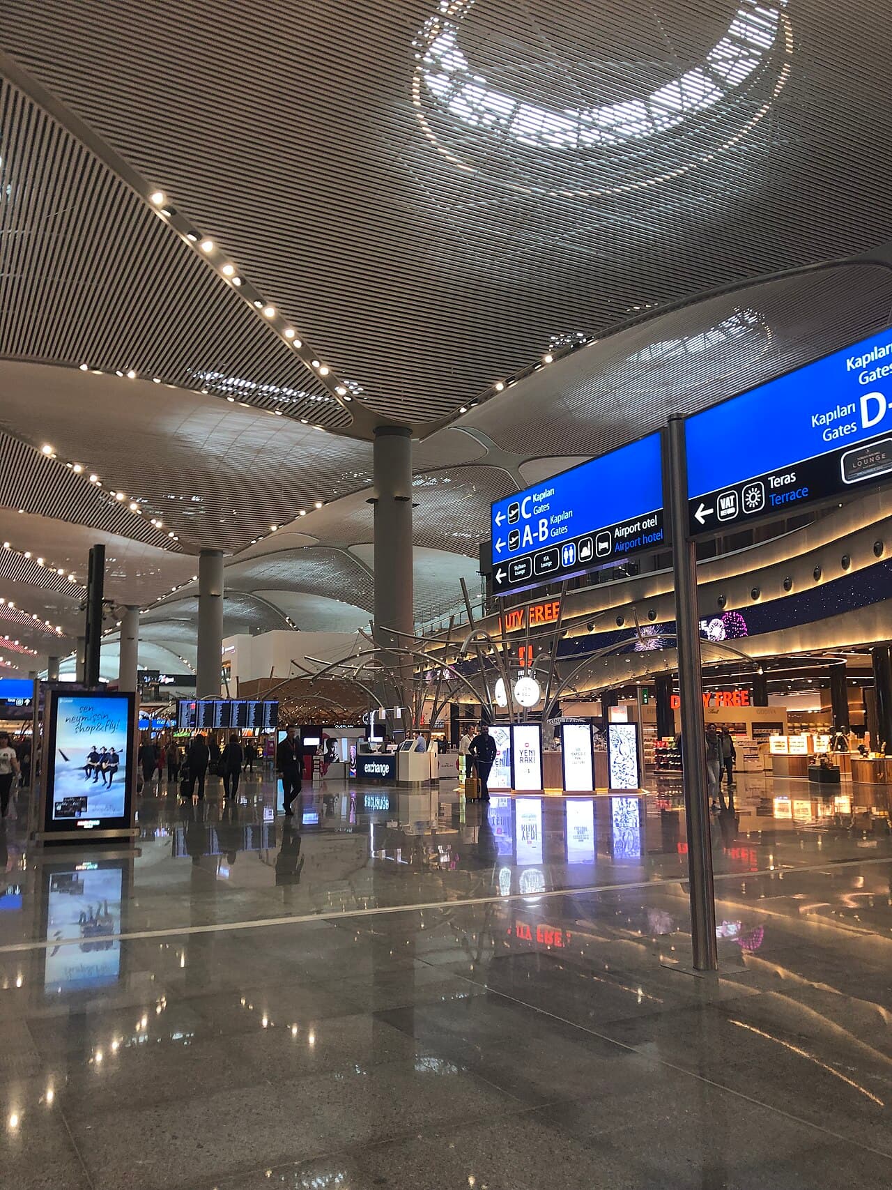 Departures hall of Istanbul Airport with gate signage and duty free shops